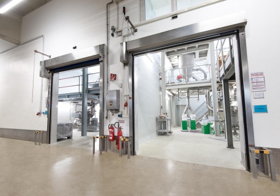 Two manufacturing plants that are separated from each other by being situated in own compartments
